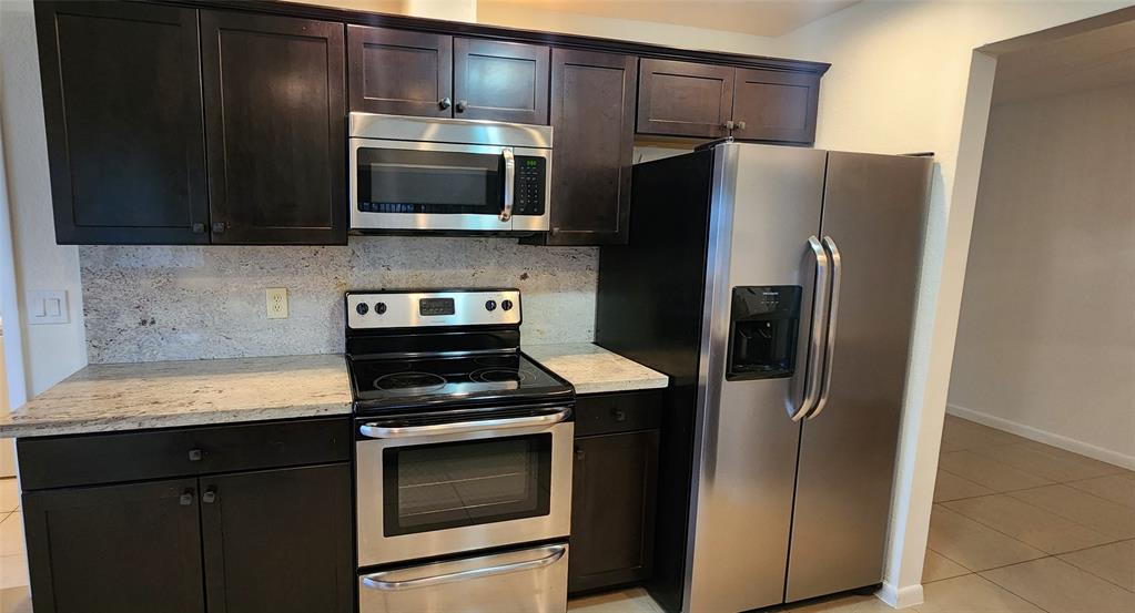 Undisclosed Address Margate, FL 33063 - Photo 3 of 26 a kitchen with a refrigerator stove and microwave