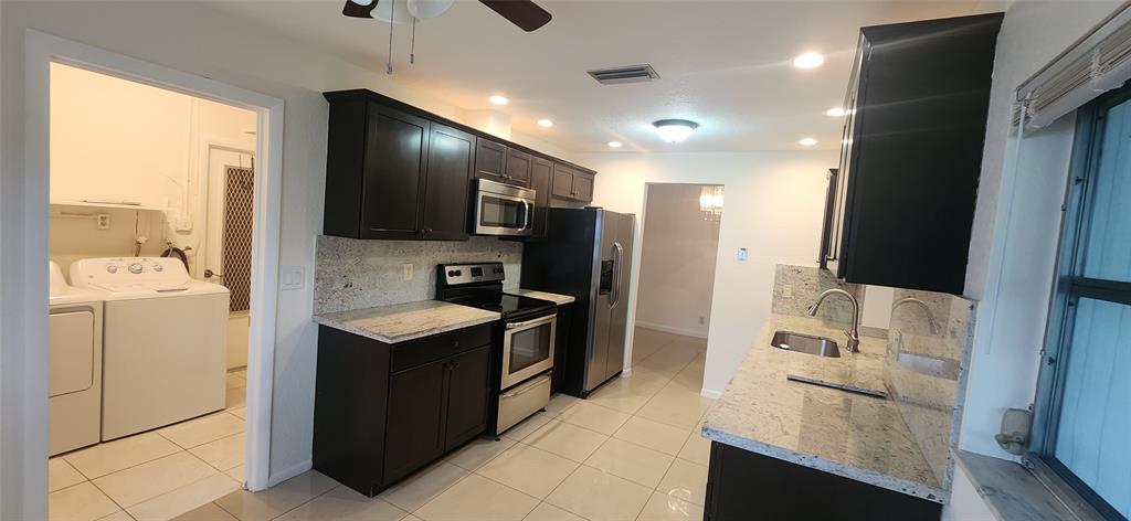 Undisclosed Address Margate, FL 33063 - Photo 4 of 26 a kitchen with stainless steel appliances granite countertop a sink stove and refrigerator