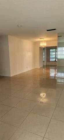 a view of a livingroom with an empty space and a window