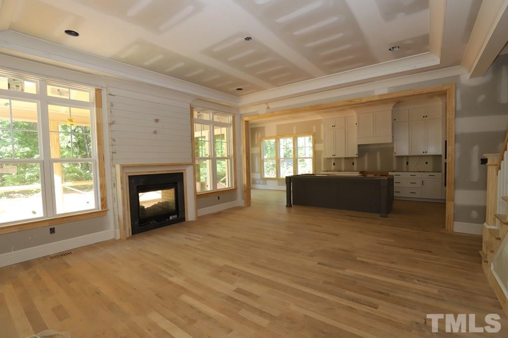 2997 Club Drive Raleigh, NC 27613 - Photo 4 of 30 a view of an empty room with a fireplace and a window
