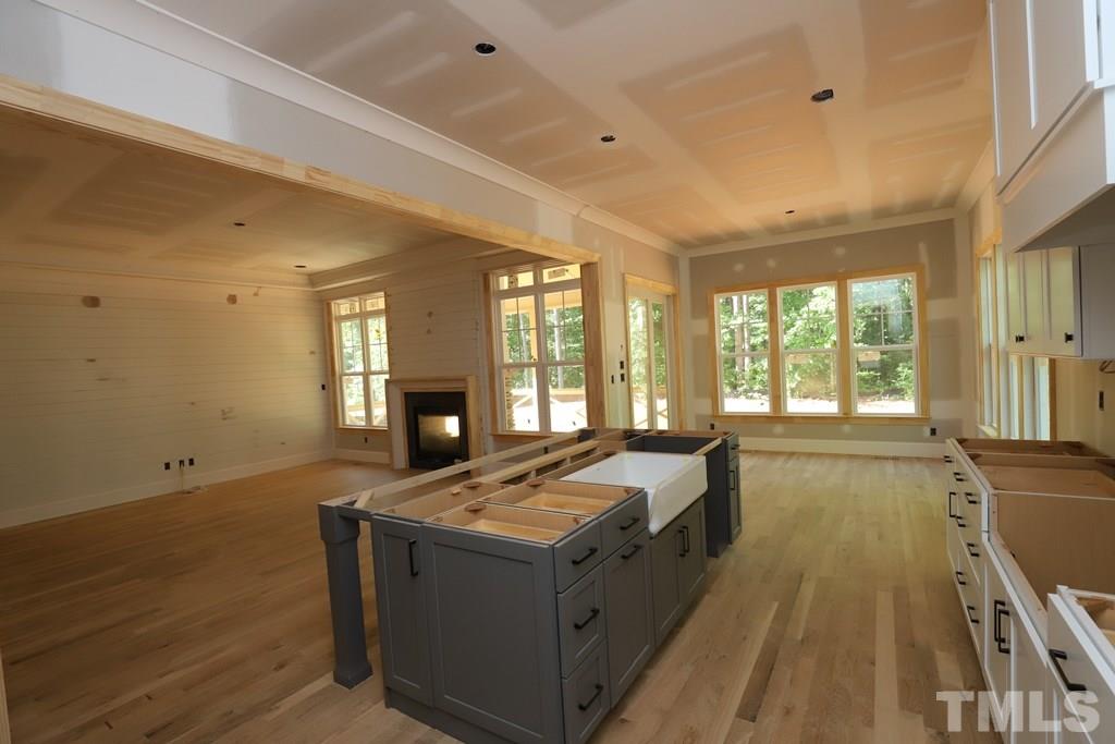 2997 Club Drive Raleigh, NC 27613 - Photo 5 of 30 a living room with stainless steel appliances granite countertop furniture and a fireplace
