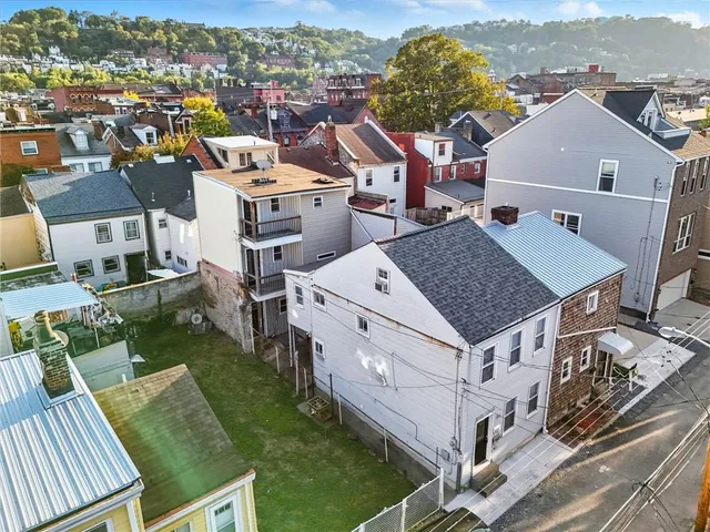 an aerial view of multiple houses with yard