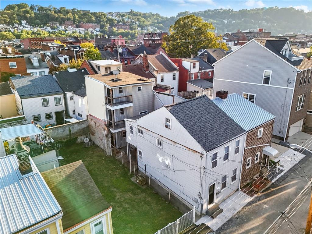 an aerial view of multiple houses with yard