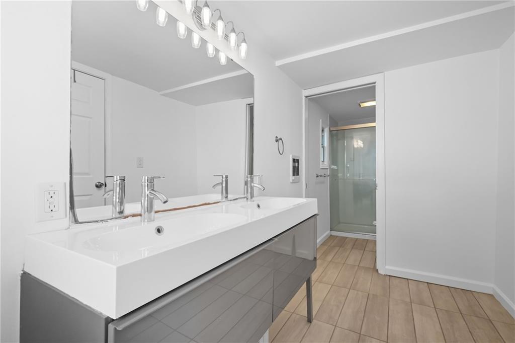 1824 Fox Way Pittsburgh, PA 15203 - Photo 22 of 49 a bathroom with a sink a mirror and a shower