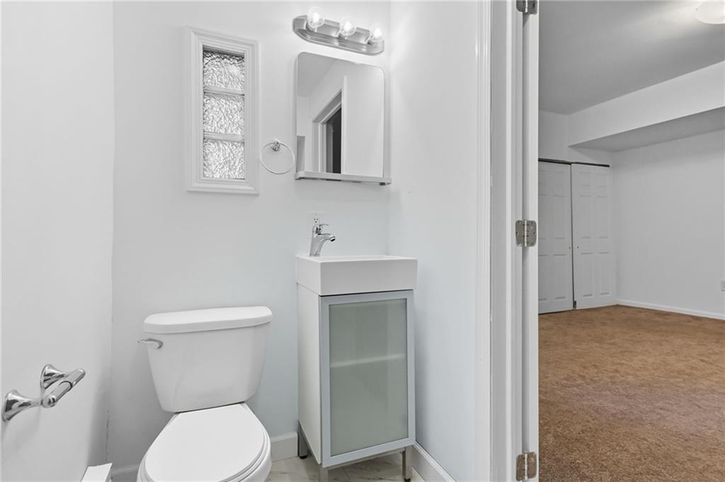 1824 Fox Way Pittsburgh, PA 15203 - Photo 31 of 49 a white toilet sitting next to a bathroom sink