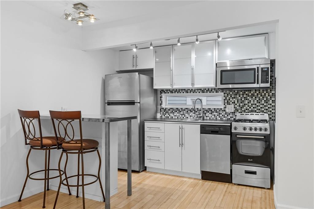 1824 Fox Way Pittsburgh, PA 15203 - Photo 36 of 49 a kitchen with kitchen island a counter top space appliances and cabinets