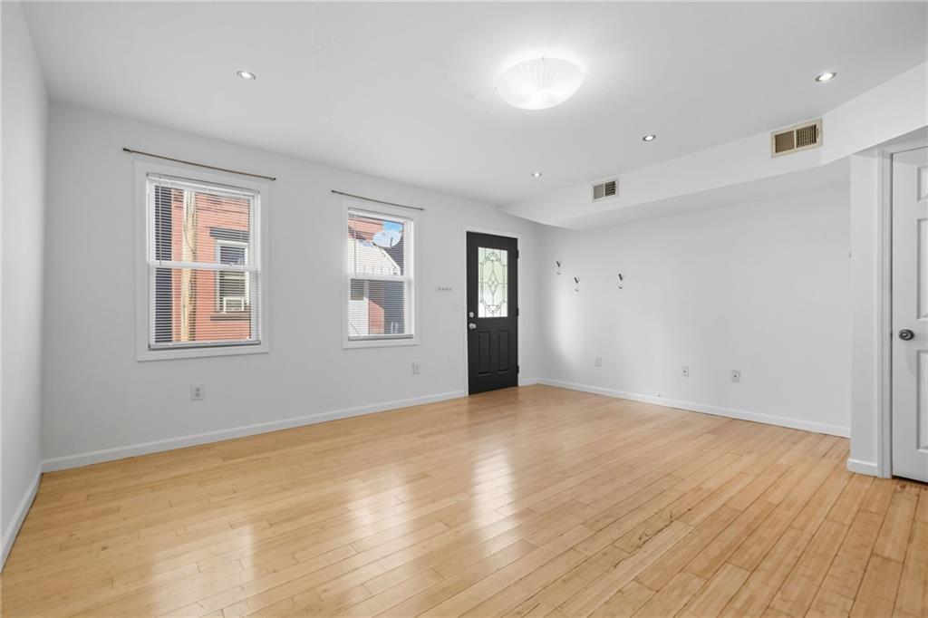 1824 Fox Way Pittsburgh, PA 15203 - Photo 8 of 49 a view of an empty room with wooden floor and a window