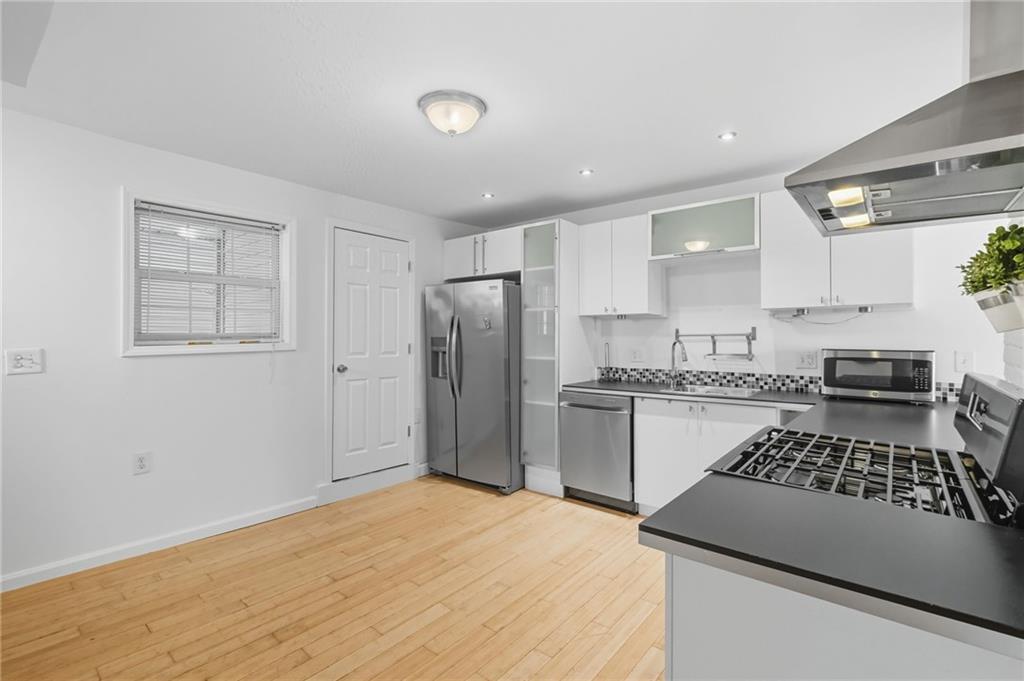 1824 Fox Way Pittsburgh, PA 15203 - Photo 10 of 49 a kitchen with stainless steel appliances granite countertop a sink stove and refrigerator