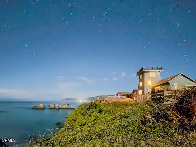 a backyard of a house with lots of green space and lake view