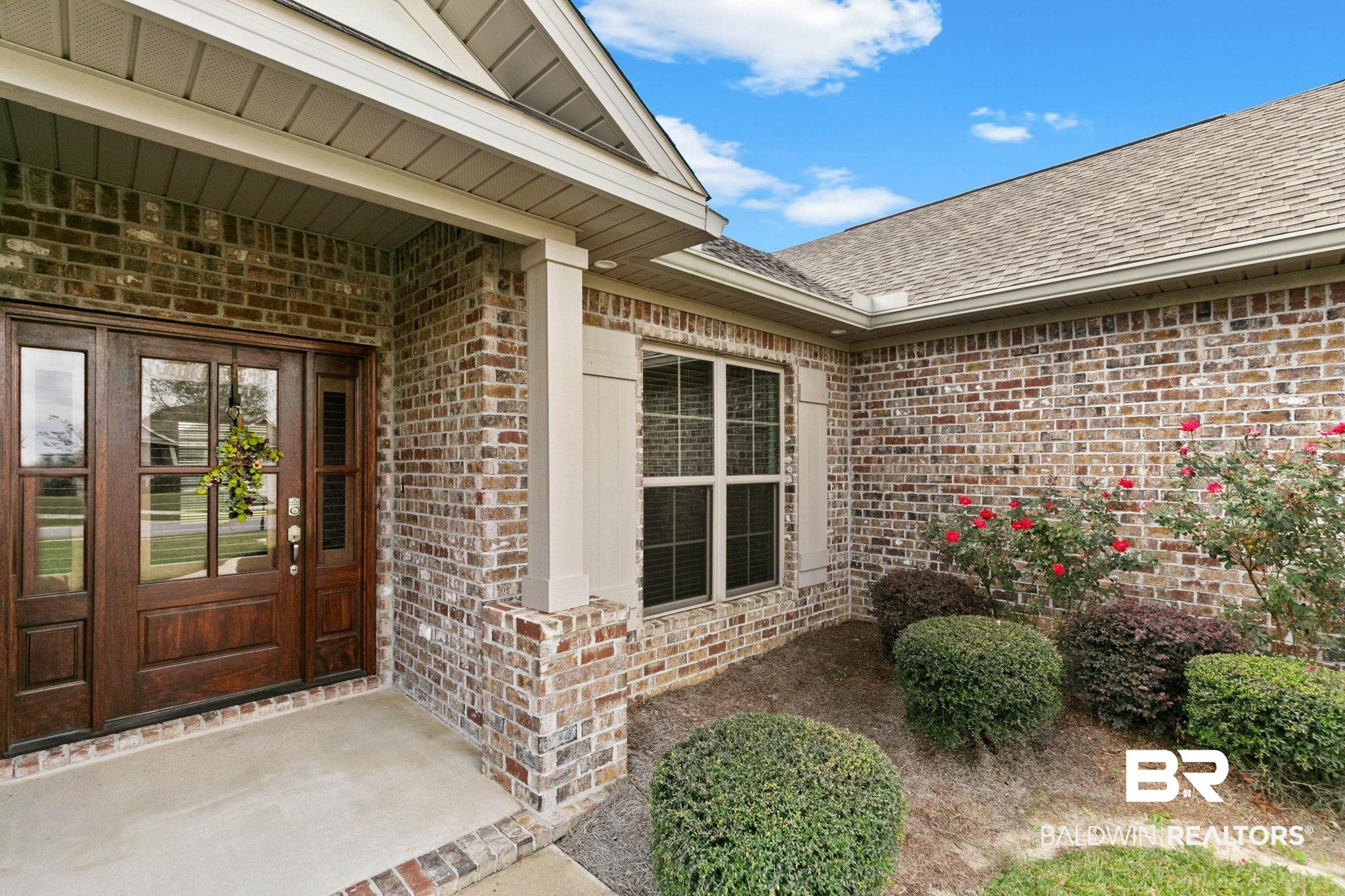 9388 Pembrook Loop Fairhope, AL 36532 - Photo 8 of 53 Property entrance with brick siding, a shingled roof, and a porch