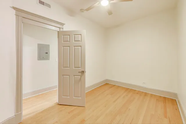 an empty room with wooden floor and closet