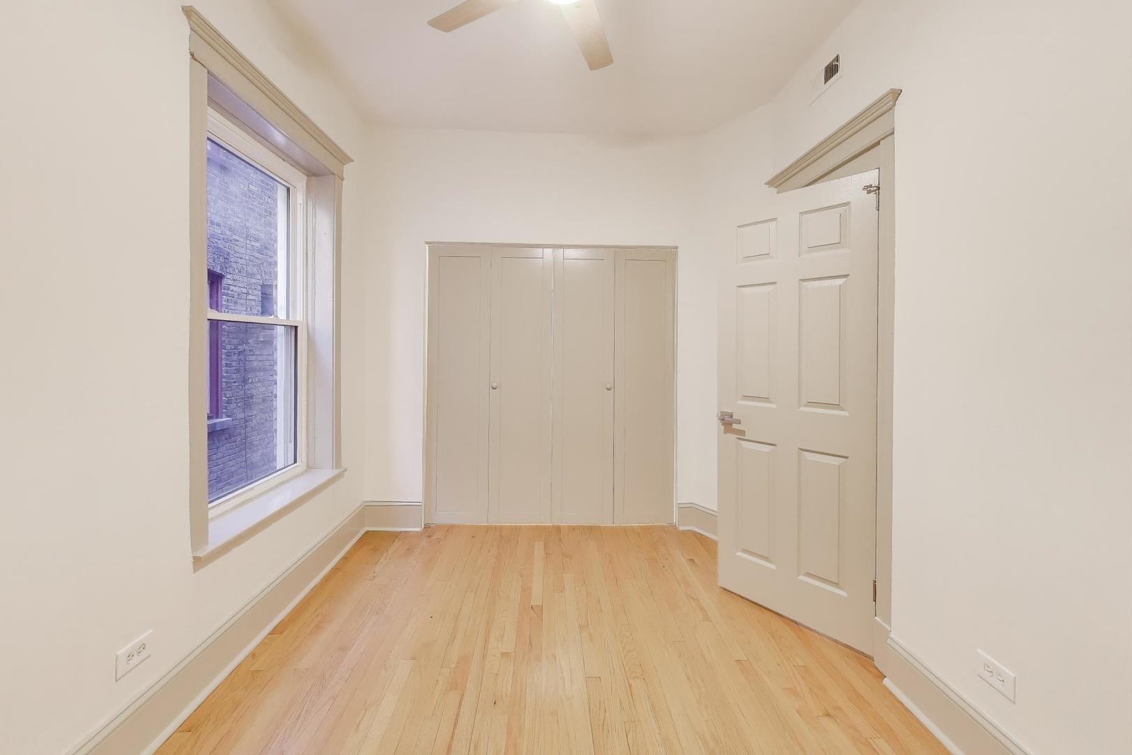 6146 South Evans Avenue, Unit 2 Chicago, IL 60637 - Photo 18 of 20 a view of a room with wooden floor and windows
