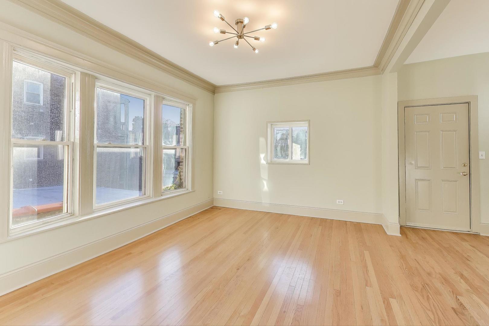 6146 South Evans Avenue, Unit 2 Chicago, IL 60637 - Photo 9 of 20 wooden floor in an empty room with a window