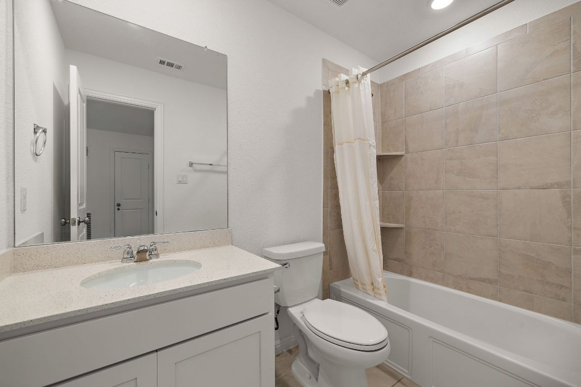 2021 Long Shadow Lane Georgetown, TX 78628 - Photo 26 of 36 a bathroom with a sink toilet and shower