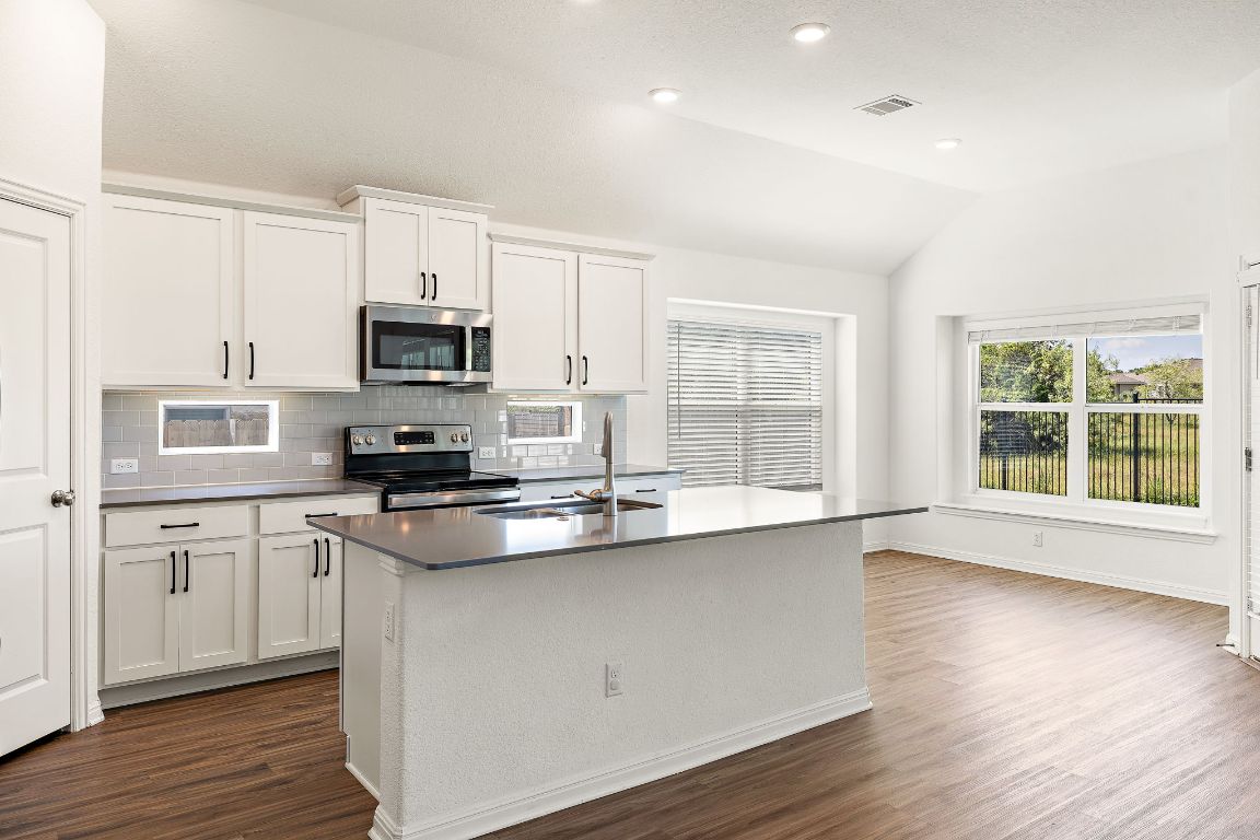2021 Long Shadow Lane Georgetown, TX 78628 - Photo 8 of 36 a kitchen with stainless steel appliances a sink stove and microwave