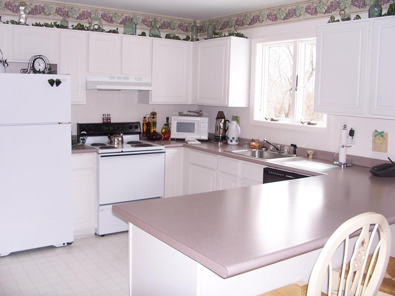 2725 Radcliff Road Bushkill, PA 18324 - Photo 2 of 9 a kitchen with granite countertop a sink a stove and cabinets