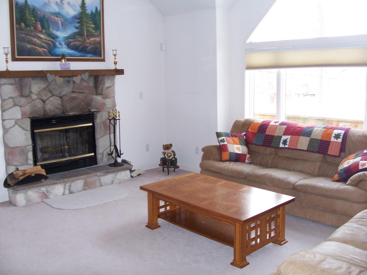 2725 Radcliff Road Bushkill, PA 18324 - Photo 5 of 9 a living room with furniture and a fireplace