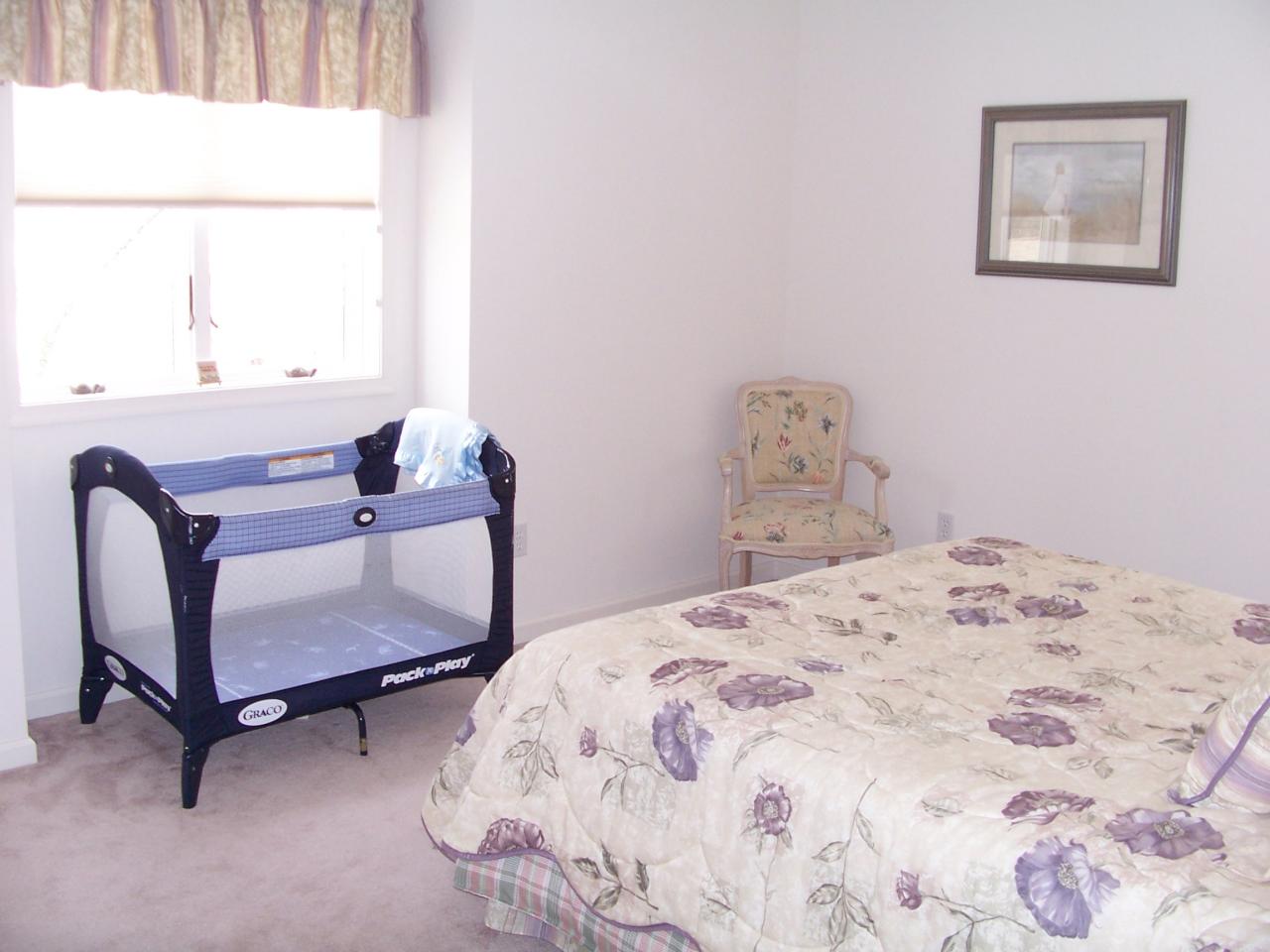 2725 Radcliff Road Bushkill, PA 18324 - Photo 8 of 9 a bedroom with a bed and a chair