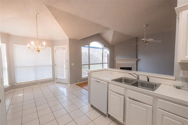 a kitchen with a sink cabinets and wooden floor