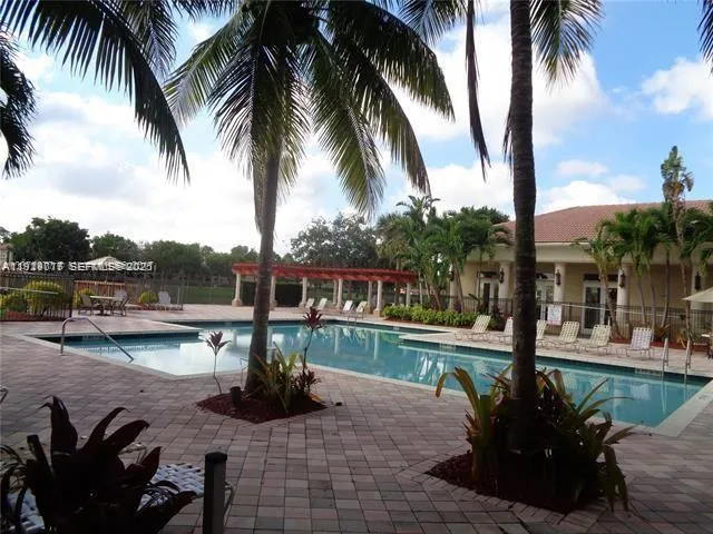 a view of a swimming pool with a table and chairs