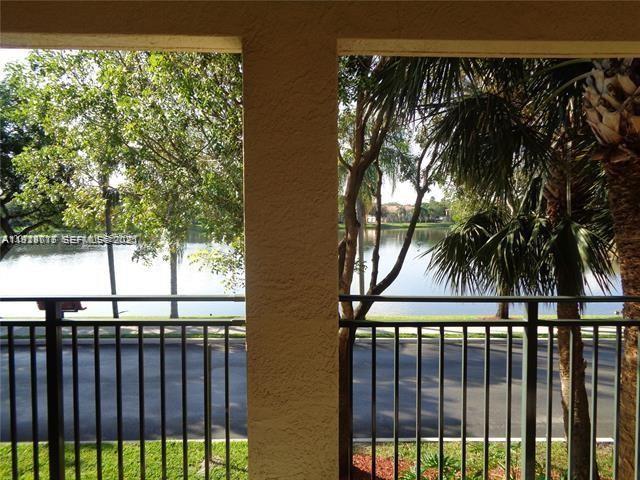 2442 Centergate Drive, Unit 205 Miramar, FL 33025 - Photo 11 of 40 a view of a palm tree from a balcony