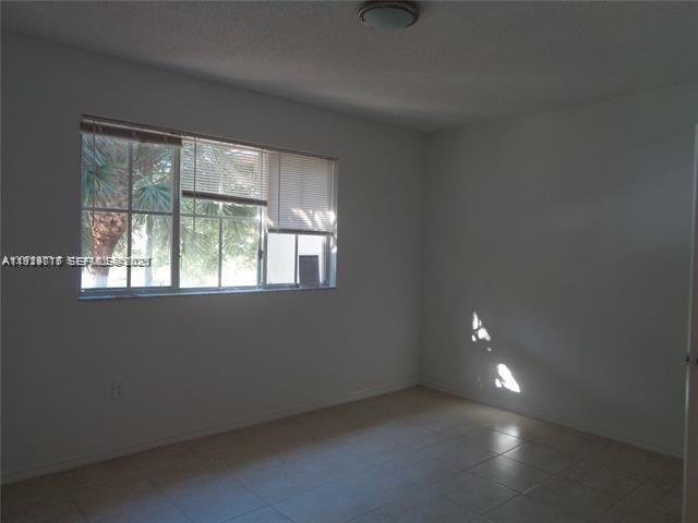 2442 Centergate Drive, Unit 205 Miramar, FL 33025 - Photo 17 of 40 an empty room with a empty space and windows