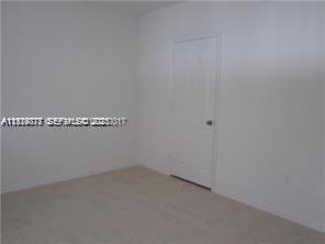 2442 Centergate Drive, Unit 205 Miramar, FL 33025 - Photo 22 of 40 a view of a room with racks on the wall