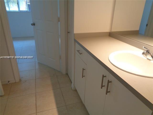2442 Centergate Drive, Unit 205 Miramar, FL 33025 - Photo 24 of 40 a bathroom with a sink and a mirror