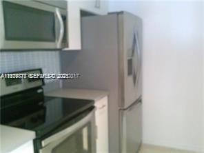 2442 Centergate Drive, Unit 205 Miramar, FL 33025 - Photo 26 of 40 a kitchen with a sink and cabinets