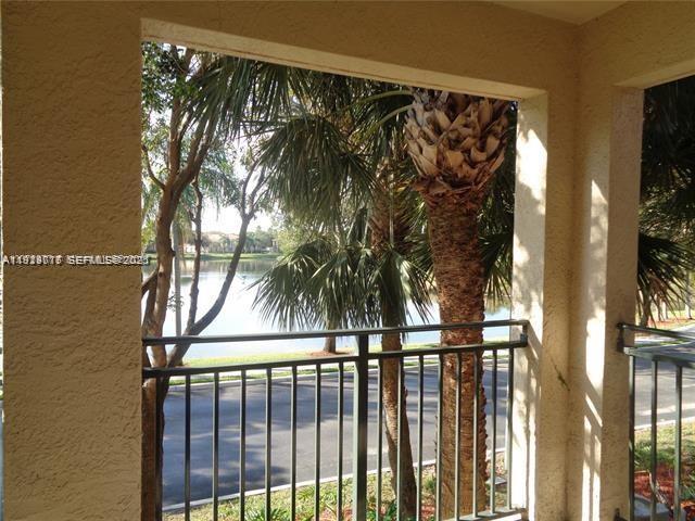 2442 Centergate Drive, Unit 205 Miramar, FL 33025 - Photo 29 of 40 a view of a palm tree from a balcony