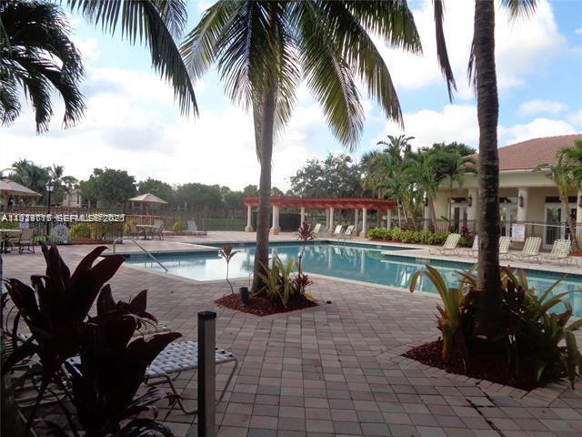 2442 Centergate Drive, Unit 205 Miramar, FL 33025 - Photo 40 of 40 a view of a lake with a table and chairs