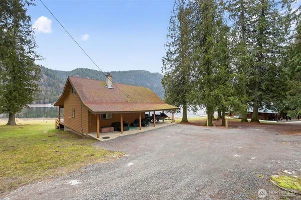 a view of a house with a yard and tree s