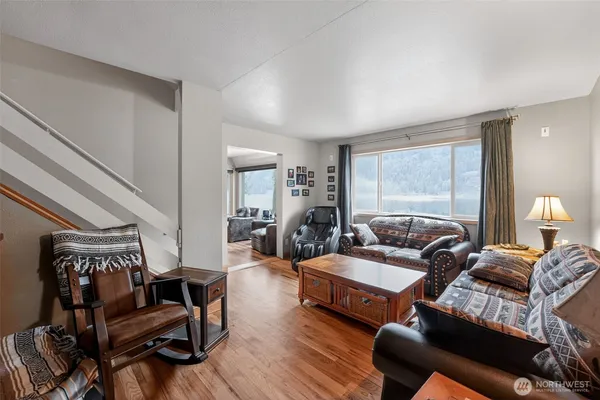 a living room with furniture and a wooden floor