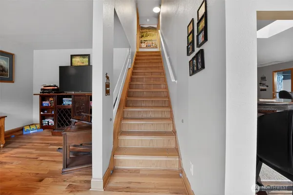 a view of entryway and hall with wooden floor