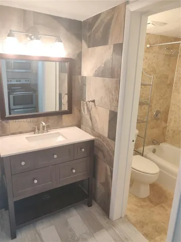 a bathroom with a toilet and a bathtub