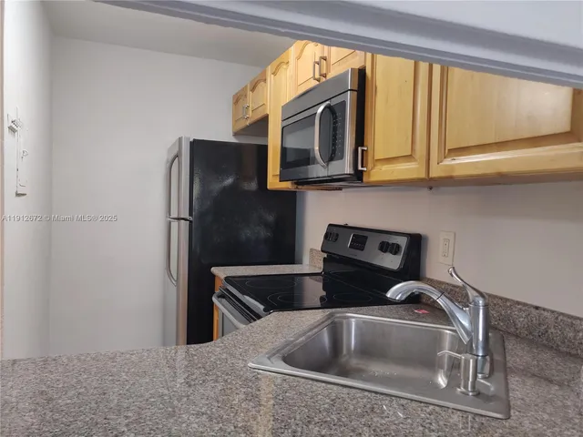 a stove top oven sitting inside of a kitchen