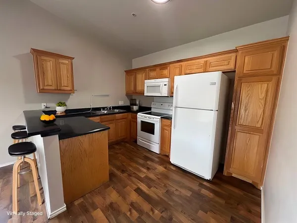 a kitchen with a refrigerator a stove top oven a sink and a window