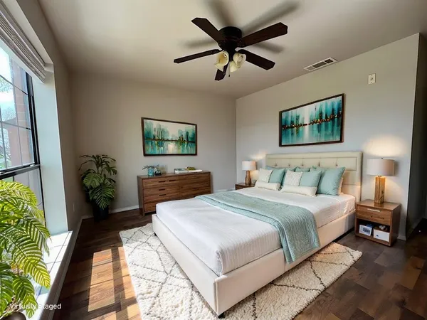 a spacious bedroom with a large bed and a chandelier