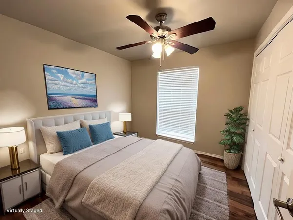 a bedroom with a large bed and a chandelier