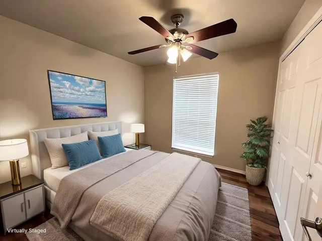 a bedroom with a large bed and a chandelier