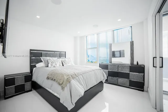 a bedroom with a bed and a couch