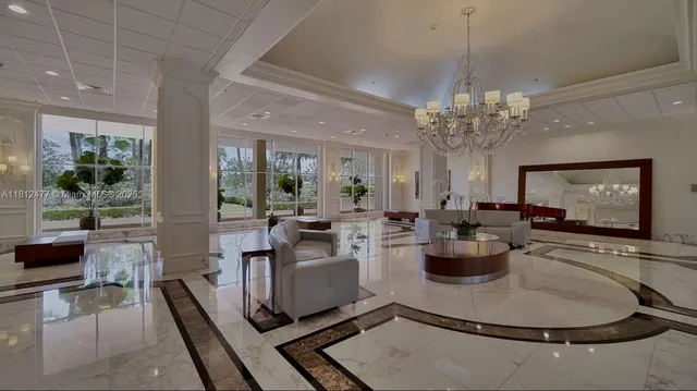 a living room with fireplace furniture and a chandelier