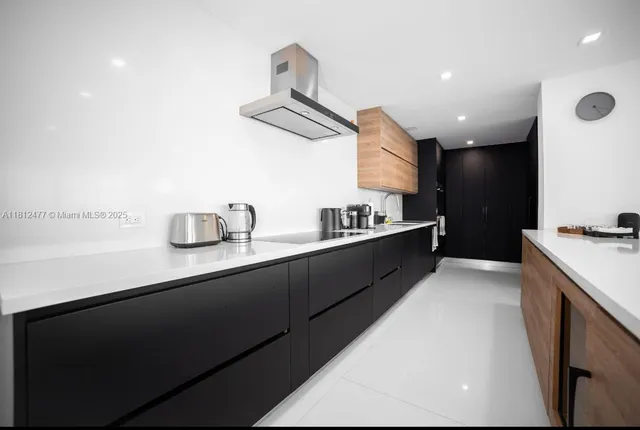 a kitchen with stainless steel appliances a sink a stove and a refrigerator