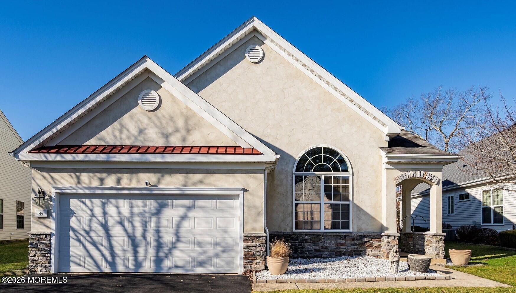 a view of a white house with large windows