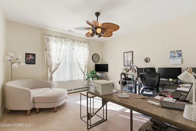 a living room with furniture a fireplace and a large window