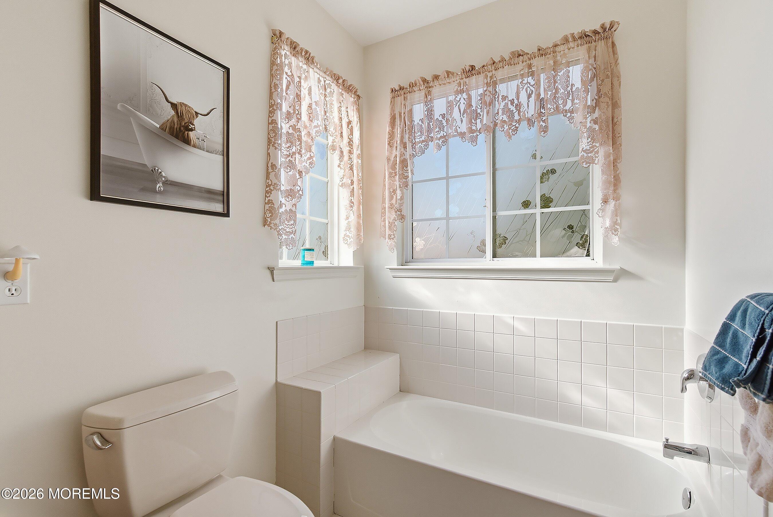 46 Hatteras Way Barnegat, NJ 08005 - Photo 8 of 27 a white toilet sitting next to a bathroom sink