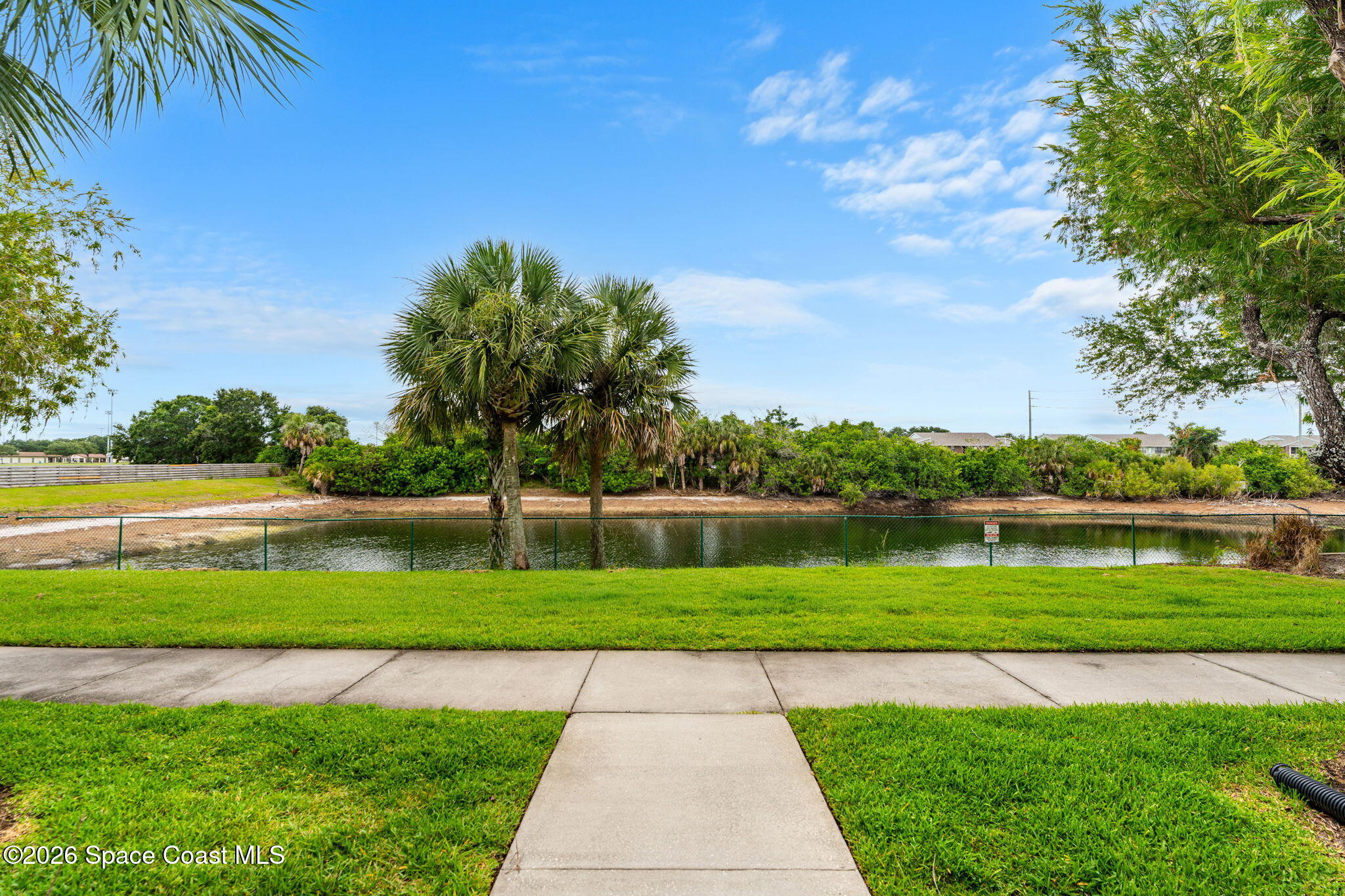 110 Turpial Way, Unit 106 Melbourne, FL 32901 - Photo 4 of 50 a view of a lake with a big yard