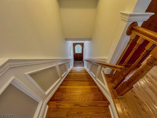 a view of a hallway with wooden floor and a floor to ceiling window