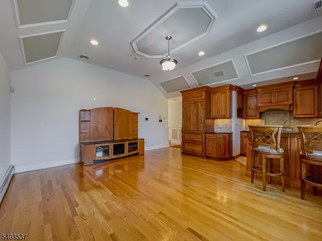 a living room with furniture and kitchen view