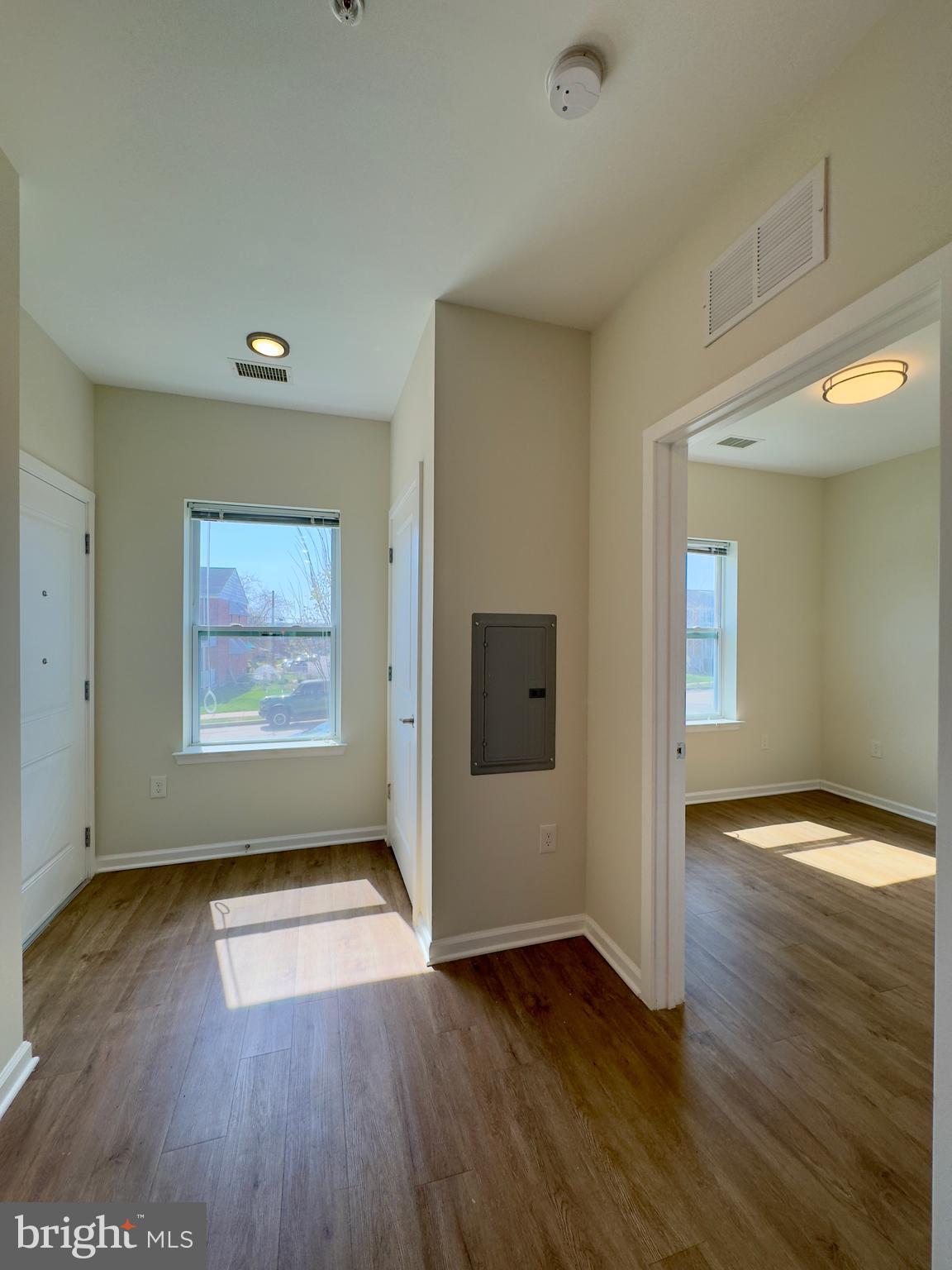 5902 Arizona Avenue, Unit 5902A Baltimore, MD 21206 - Photo 3 of 13 an empty room with wooden floor and windows